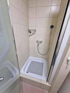 a small bathroom with a shower and a sink at Studio SVACIC self check in in Osijek