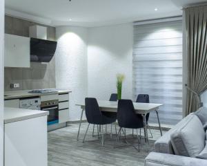 a kitchen and dining room with a table and chairs at 1125 City Apartment in Accra