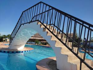a bridge over the swimming pool at a resort at Coconut Beach in Majanji