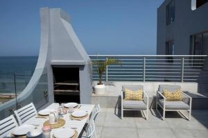 a patio with a table and chairs and a fireplace at 20 Marginella with inverter in Umdloti