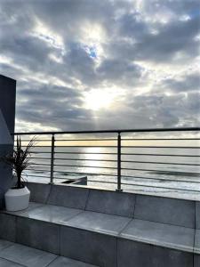 a view of the ocean from a balcony with a potted plant at 20 Marginella with inverter in Umdloti