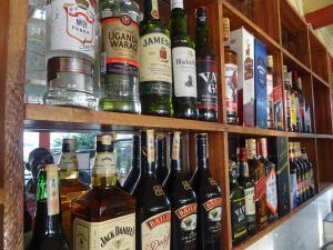 a bunch of bottles of wine on shelves at Coconut Beach in Majanji