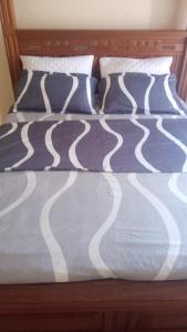A bed or beds in a room at KITWE PEMBENI APARTMENTS