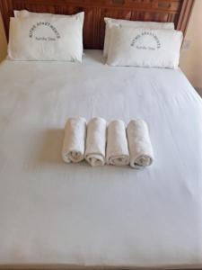 a group of rolled towels on a bed at KITWE PEMBENI APARTMENTS in Mombasa