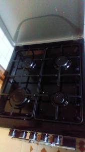 a stove top with four burners on top of it at KITWE PEMBENI APARTMENTS in Mombasa