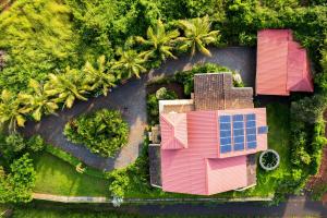 an overhead view of a pink house and palm trees at Sea Nest Villa, 3BHK Panoramic Sea View , Ganpatipule in Ratnagiri
