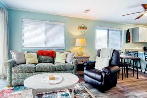 a living room with a couch and chairs and a table at North Myrtle Hideaway in Myrtle Beach