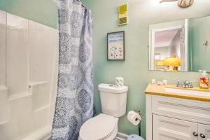 a bathroom with a toilet and a sink and a shower at North Myrtle Hideaway in Myrtle Beach
