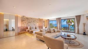 a living room with a couch and a table at Villa Hotel Tamara in Kaş