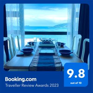 a dinner table with a view of the ocean at Private Corner Stay! Ocean-View, Walk to Jetty & Food Spots-Mango House1 in Kota Kinabalu