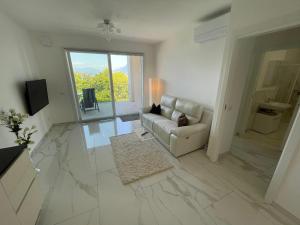 a living room with a couch and a large window at Isole in Baveno