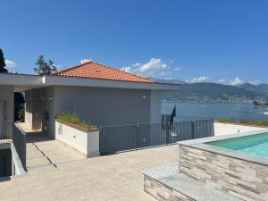 uma casa com piscina ao lado de uma casa em Isole em Baveno