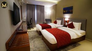 Letto o letti in una camera di Muscat Express Hotel