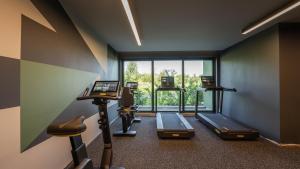 a gym with three treadmills and a large window at HVD Reina del Mar - Premium Spa Service & Free Parking in Obzor