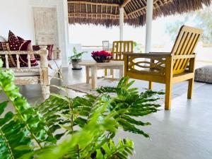 a living room with two chairs and a table at Beba.Beach.House in Watamu