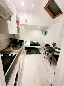 a kitchen with a sink and a living room at (S7) Great Studio Next To A Tube Station! in Harrow on the Hill