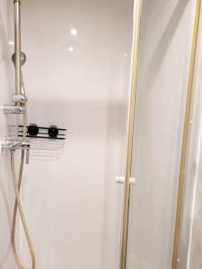 a shower stall with a glass door with a shower at (S7) Great Studio Next To A Tube Station! in Harrow on the Hill