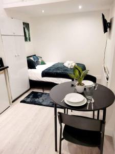 a small room with a table and a bed at (S7) Great Studio Next To A Tube Station! in Harrow on the Hill