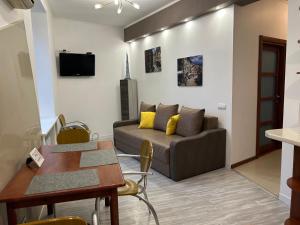 a living room with a couch and a table at Pavlovskaya square in Kharkiv