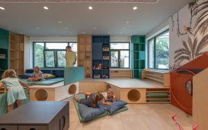a childrens play room with children sitting on beds at HVD Reina del Mar - Premium Spa Service & Free Parking in Obzor