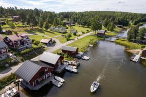 a group of boats are docked in a river at Seaside Cottage House nr 1, Saltvik Hudiksvall in Hudiksvall