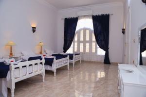 Postel nebo postele na pokoji v ubytování Luxor Oasis Guest House + 37 fotografií