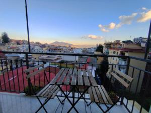 a table and chairs on a balcony with a view of a city at Montesanto 77 casa panoramica al centro storico in Naples