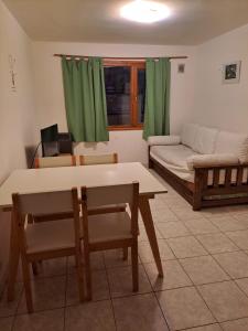 a living room with a table and a couch at Hermoso departamento vivi Bariloche todo el año in San Carlos de Bariloche