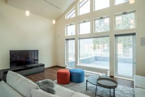 a living room with a couch and a large window at Blue Heron in Rusutsu