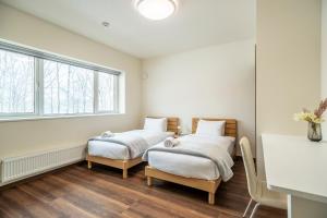 Ένα ή περισσότερα κρεβάτια σε δωμάτιο στο Blue Heron