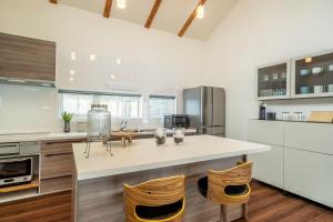 a kitchen with a white counter top and wooden floors at Blue Heron in Rusutsu