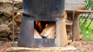 a wood fired oven with a fire in it at Diamond Vault Rustic Mountain Cabins in Hogsback