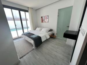 A bed or beds in a room at 3bedroom apartment with a private pool
