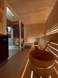 a sauna with a wooden bowl on a table at Hôtel Aalborg in Les Deux Alpes