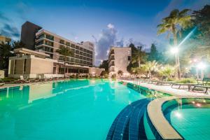 a large swimming pool at a resort at night at Hotel Pia Bella in Kyrenia