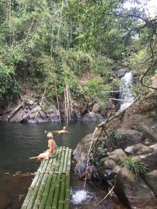 a woman sitting on a raft in a river at Happy Homestay Banlung & Trekking in Banlung