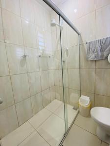 a bathroom with a shower and a toilet at Rota BH Hostel in Belo Horizonte