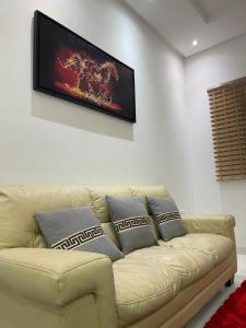 a living room with a couch and a flat screen tv at Al Qalah flats 