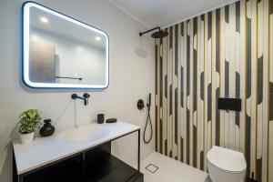 a bathroom with a sink and a mirror at Exarcheia Vibe Penthouse 1 in Athens