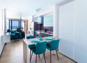 a kitchen and living room with a table and chairs at Calypso in Cotillo