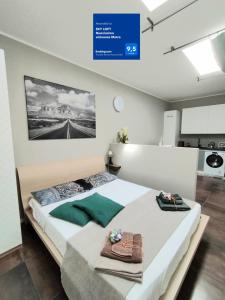 a bedroom with two beds and a sign on the wall at SKY LOFT Nuovissimo vicinanze Metro in Turin