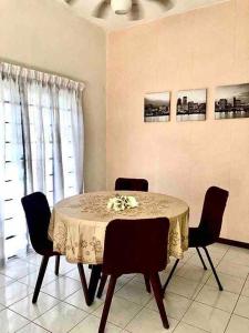 a dining room with a table with chairs and a tableablish at SUPER COMFY HOME @ KULIM CITY in Kulim