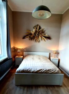 a bedroom with a bed with two night stands and two lamps at Vogtlandperle in Oelsnitz