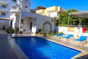 a swimming pool in front of a house at Luxor Oasis Guest House in Luxor