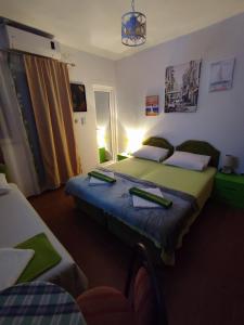 a hotel room with two beds and a window at Apartments Blago Sutomore in Sutomore
