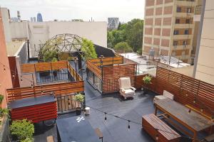 an overhead view of a balcony with wooden benches at Casa Urbana Hotel in Cordoba
