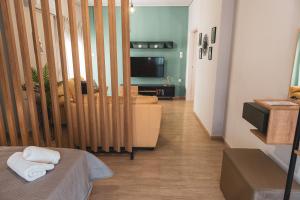 a room with a bed and a living room at Casa bonita in the center of Volos in Volos