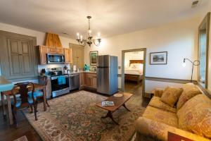 a living room with a couch and a kitchen at Thomas Rose Inn in Lewisburg
