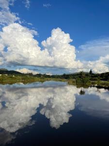 a reflection of clouds in the water of a lake at Pousada Lagos de Minas in Santa Cruz de Minas