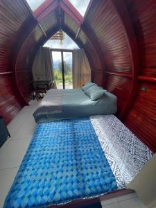 1 dormitorio con 1 cama grande en una habitación redonda en Glamping Campo Alegre, en Cartago